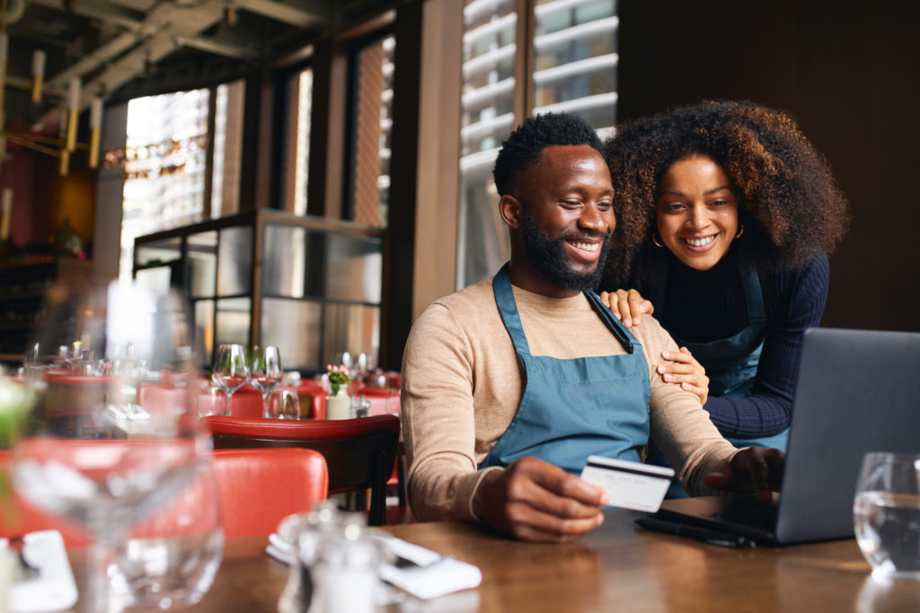 restaurant-owners-using-credit-card-online-2022-05-08-22-16-16-utc-1024x683 Decoding 504 loan terms: The ultimate guide for restaurant owners eyeing business expansion